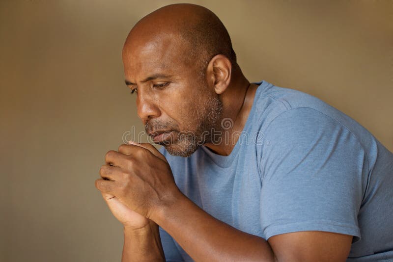 African American in deep thought and prayer. African American in deep thought and prayer.
