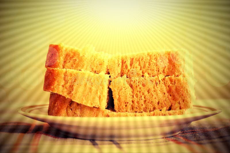 A oração Jesus dá-nos o pão diário placa com partes de raio do pão imagens de stock royalty free A oração Jesus dá-nos o pão diário placa com partes de raio do pão imagens de stock royalty free