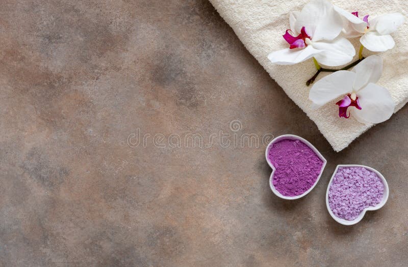 Orchid flower, aroma sea salt, natural cosmetic clay, and towel. Natural skin care. Spa kit for beauty and health. Close up, top