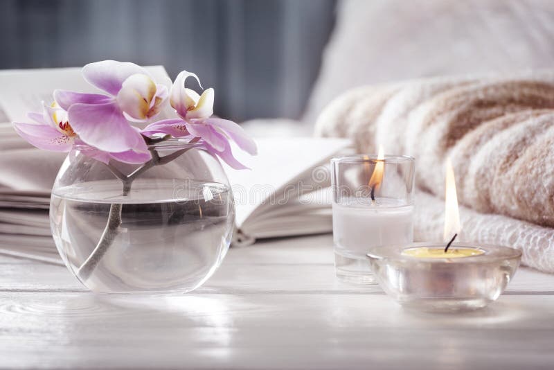Orchidea w wazowego następnego ot płonących świeczkach przed łóżkiem opracowane do domu żywy wewnętrznego styl retro pokoju Wciąż obrazy stock Orchidea w wazowego następnego ot płonących świeczkach przed łóżkiem opracowane do domu żywy wewnętrznego styl retro pokoju Wciąż obrazy stock