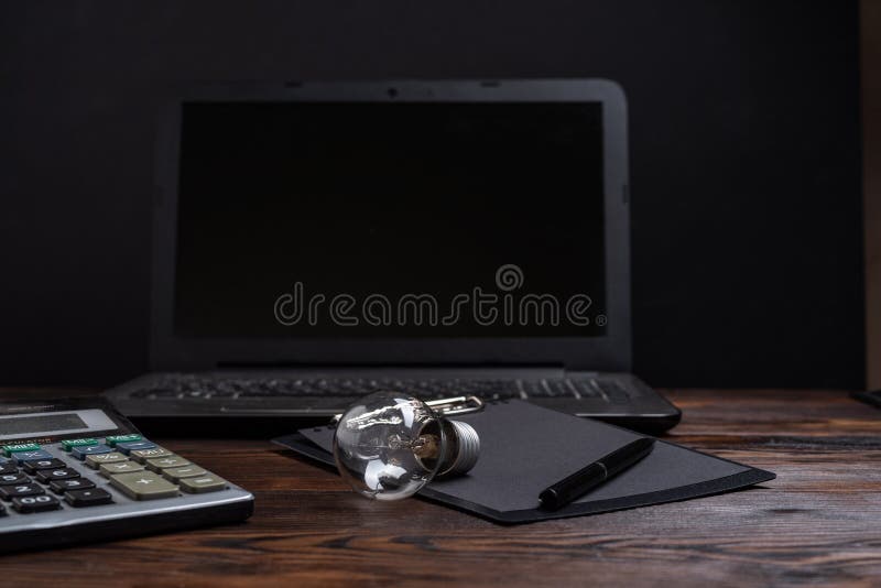 Ordinary Incandescent Lamp and Office. Light Bulb and Calculator Stock