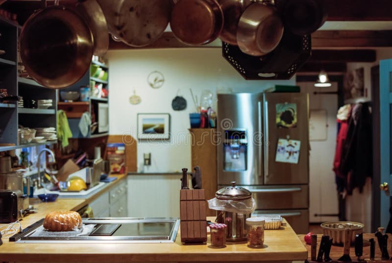 A Kitchen in a Rustic Home with Hanging Pots and Pans Stock Photo