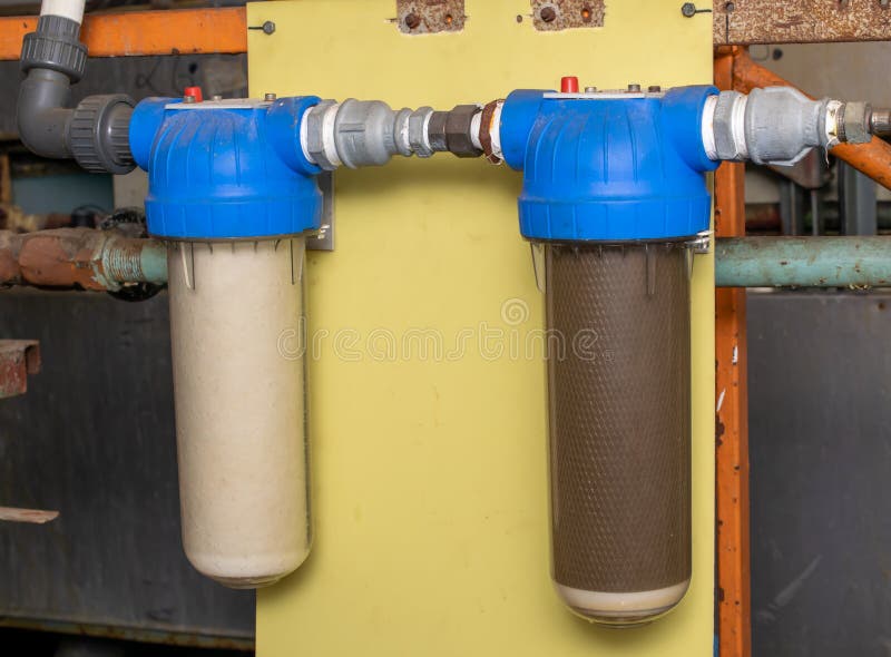 Ordinary water filter, screwed to the wall stock image