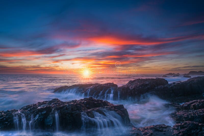 Oregon coast sunset and ocean waterfalls. This is a photograph of Beluga rock sunset with beautiful clouds and ocean waterfalls