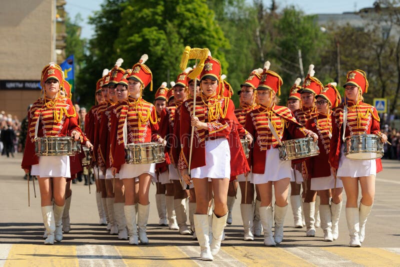 Orel, Russia - May 9, 2016: Celebration of 71th anniversary of the Victory Day (WWII). Girls in red hussar uniform and short skirts marching horizontal. Orel, Russia - May 9, 2016: Celebration of 71th anniversary of the Victory Day (WWII). Girls in red hussar uniform and short skirts marching horizontal