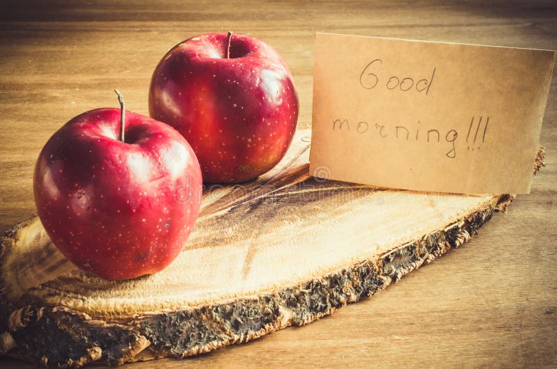Organic Apples and Good Morning Note on Rustic Wooden Background. Stock