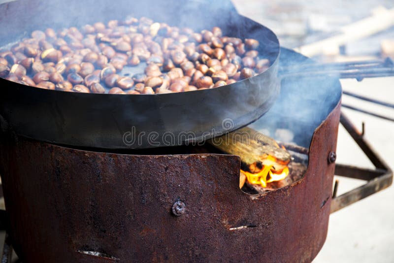 Organic Brown Chestnuts Roasting over a hot fire stock photos