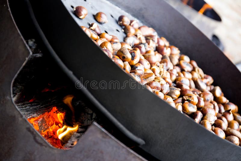 Organic Brown Chestnuts Roasting over a hot fire royalty free stock images