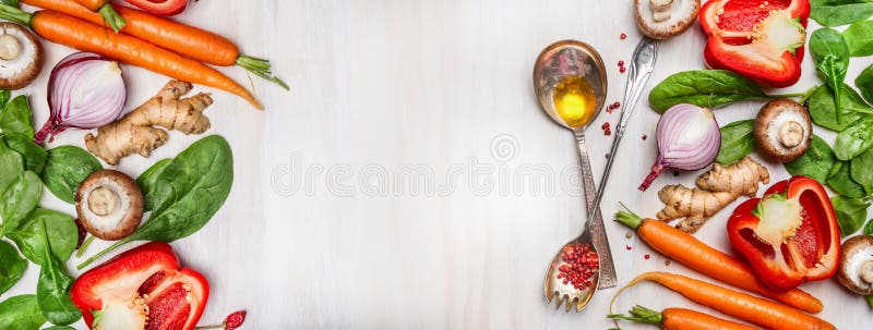 Organic clean vegetables assorted with cooking spoons and oil on white wooden background, top view, banner.
