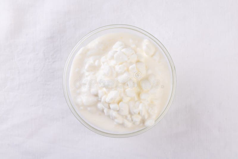 Organic cottage cheese in a bowl on kitchen table royalty free stock photo