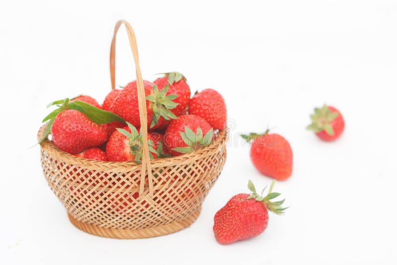 Organic, fresh strawberries in wicker basket on white background royalty free stock photo Organic, fresh strawberries in wicker basket on white background royalty free stock photo