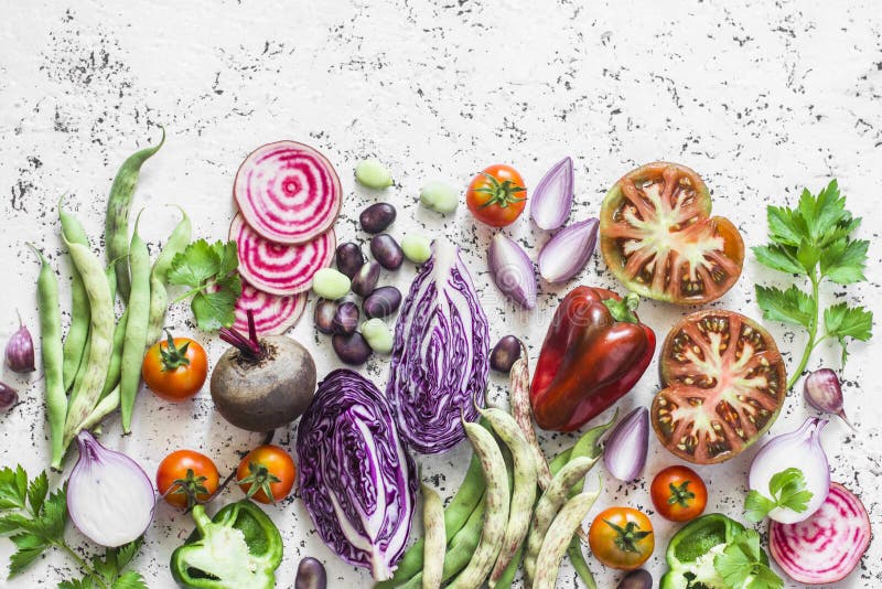 Organic fresh vegetables background. Cabbage, beets, beans, tomatoes, peppers on a light background, top view