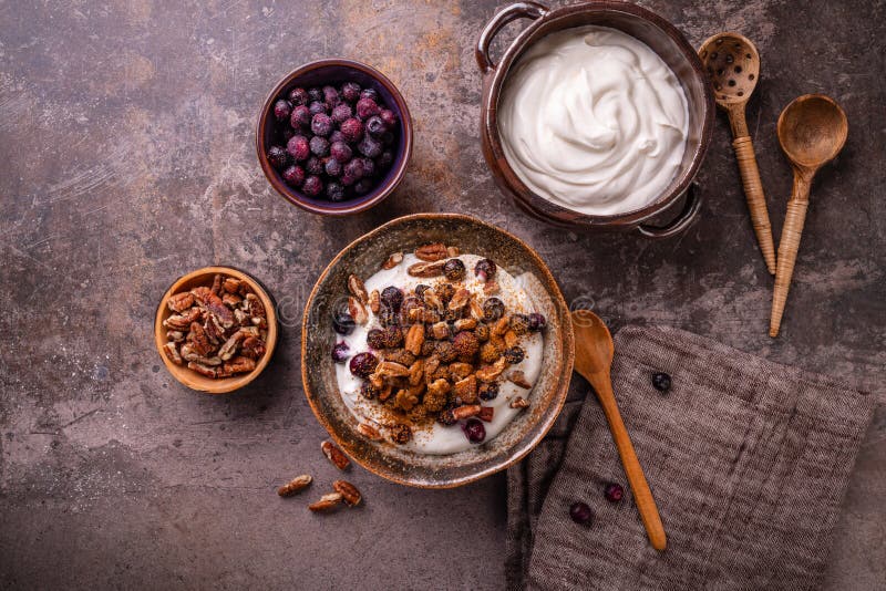 Organic Greek yogurt with pecan nuts, blueberries and cinnamon stock photo