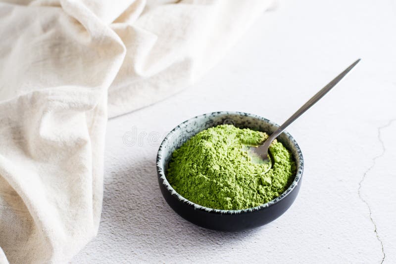 Organic Green Matcha Tea Powder in Bowl and Spoon on Table Stock Image
