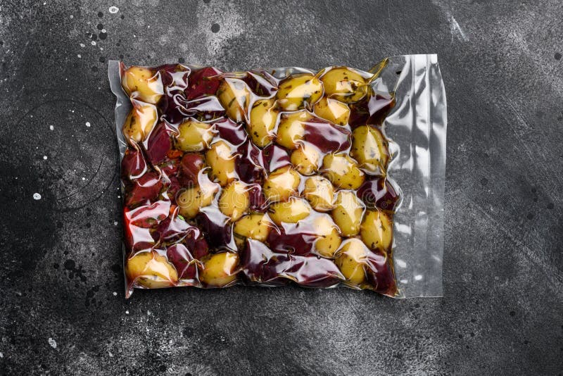 Organic Olives Vacuum Pack, on Black Dark Stone Table Background, Top