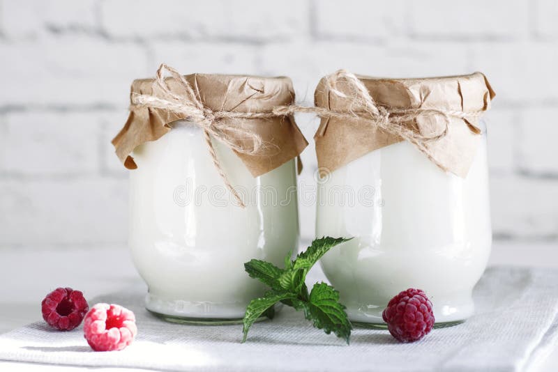 Organic probiotic milk kefir drink or yogurt in glass containers,on the white grey background. Gut health. Probiotic cold