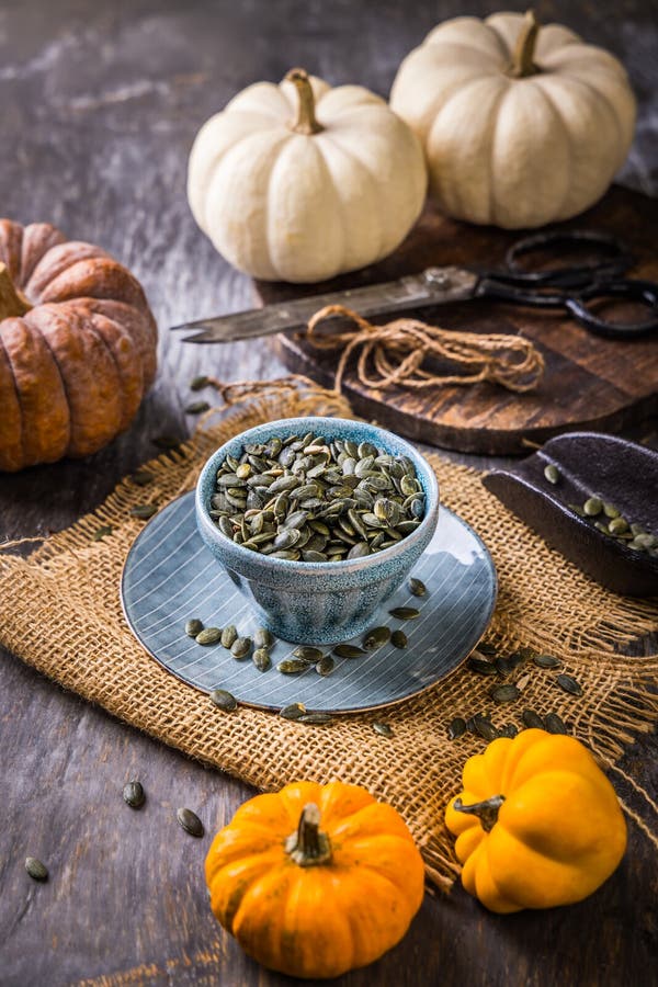 Organic pumpkin seeds with scoop in a bowl stock photo