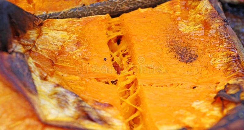 Organic Pumpkin slice baked for Halloween holiday. Colorful baked squash background. Pumpkin texture pattern. Sweet Grilled pumpki stock photos Organic Pumpkin slice baked for Halloween holiday. Colorful baked squash background. Pumpkin texture pattern. Sweet Grilled pumpki stock photos