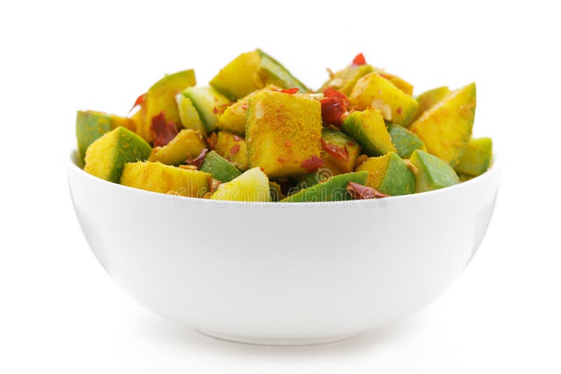 Organic sliced Indian Mango (Mangifera indica) in white bowl.