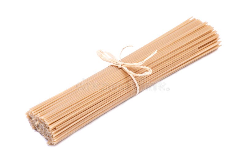 Organic uncooked Brown Rice Spaghetti pasta tied with a straw isolated on white background. Gluten-free and sodium-free royalty free stock image Organic uncooked Brown Rice Spaghetti pasta tied with a straw isolated on white background. Gluten-free and sodium-free royalty free stock image