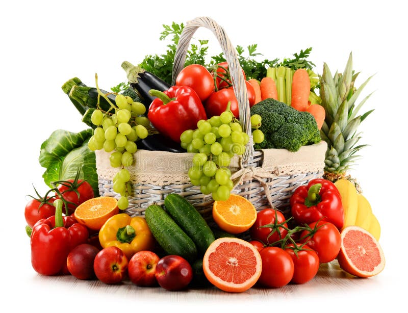Organic vegetables and fruits in wicker basket on white