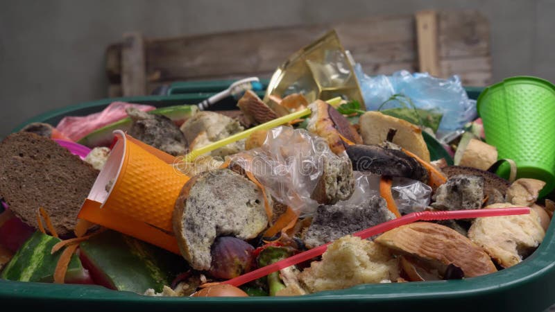 Organic waste, unsold food, uneaten bread, plastic in the trash can. The food throw out in household, home kitchen or in