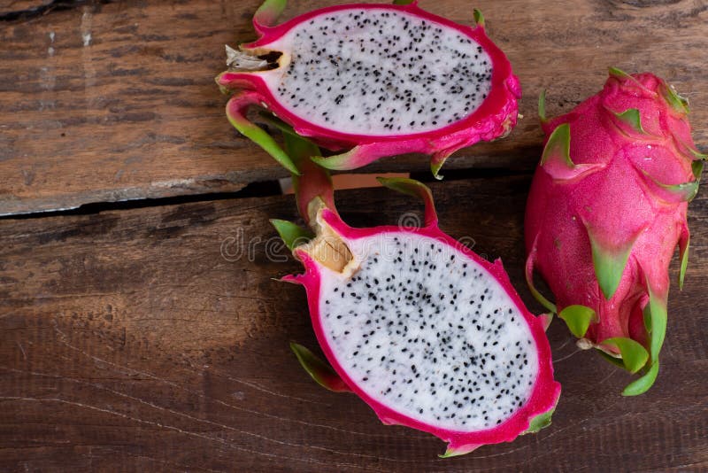 Organic White Fresh Dragon Fruit Cut into Half on Wooden Chopping Board