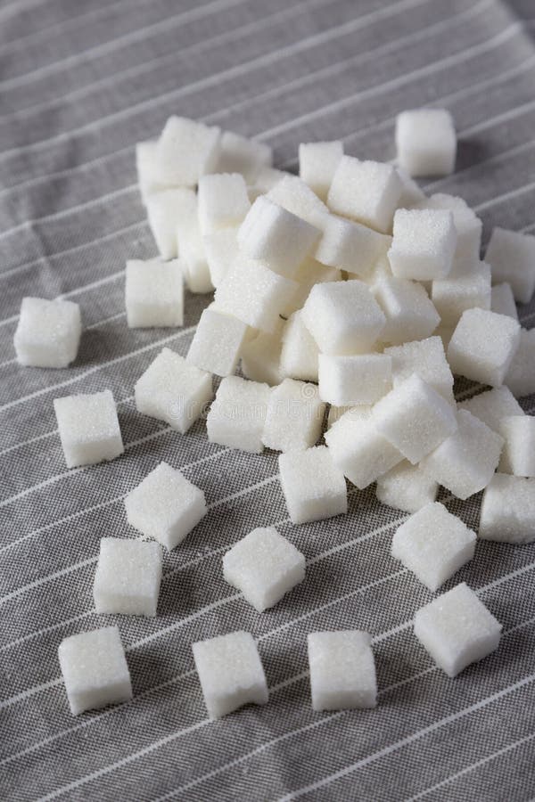 Organic White Sugar Cubes on Cloth, Side View. Closeup Stock Photo
