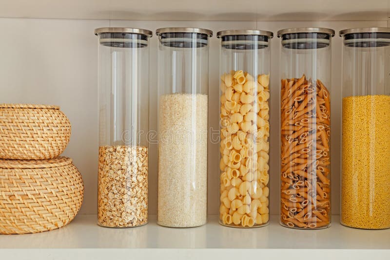 Organization of Storage in the Kitchen. Pasta, Rice and Cereal in Glass Containers on a Kitchen