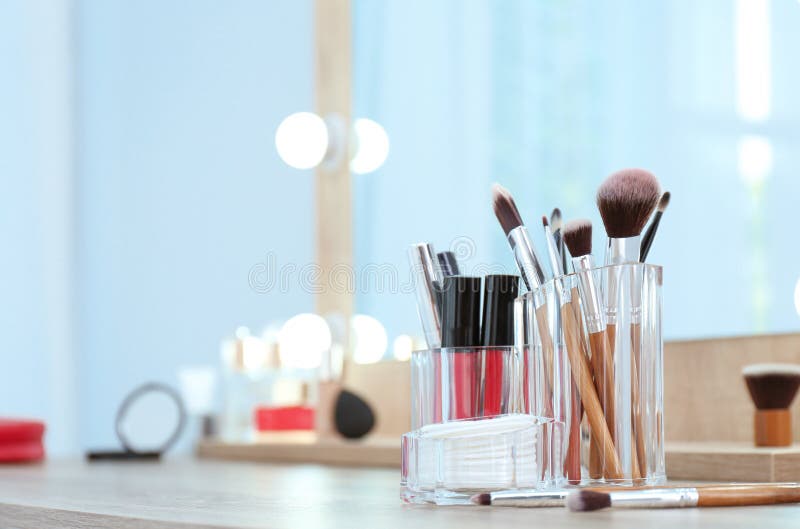Organizer with Cosmetic Products for Makeup on Table Near Mirror. Stock