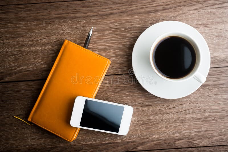 Organizer with cup of coffee and mobile phone