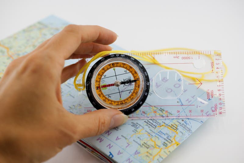 Orienteering Compass and Map with hand. Compass on map
