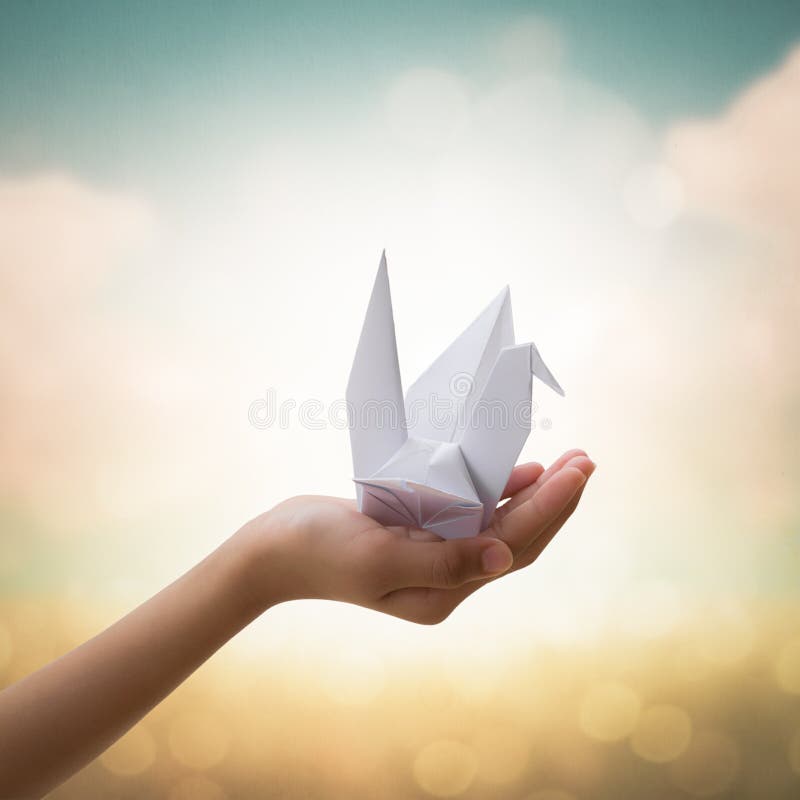 Origami bird on children s hand