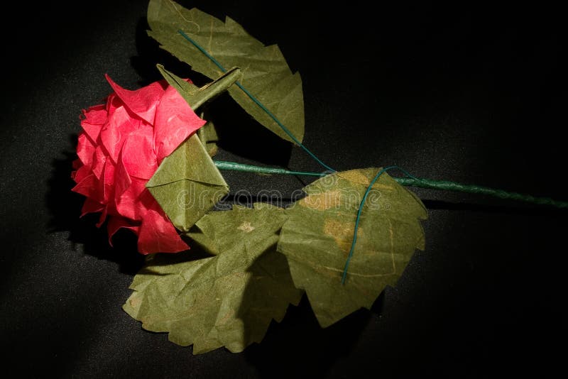 Origami rose in dark background