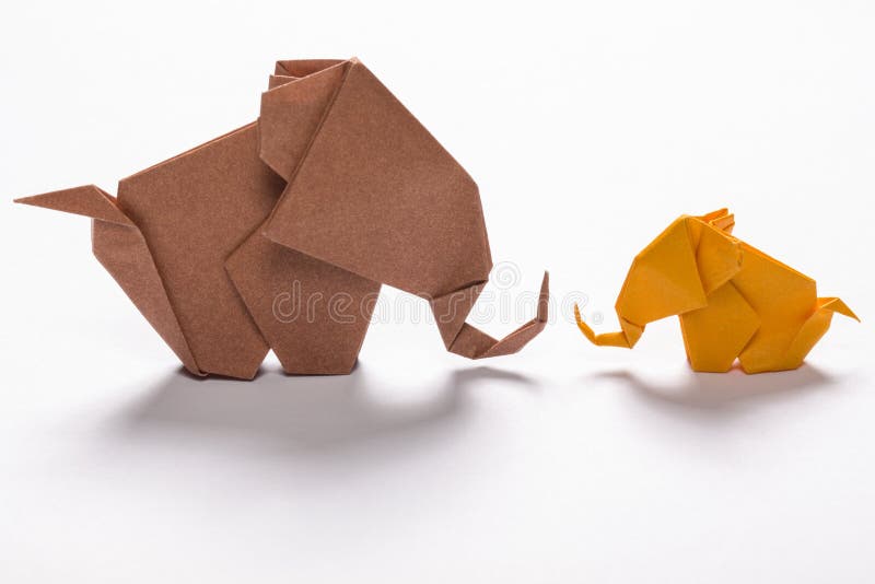 The origami elephant family in white background. The origami elephant family in white background.