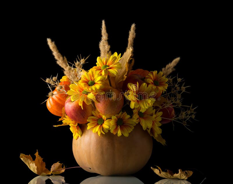 Original autumn composition in pumpkin isolated on black