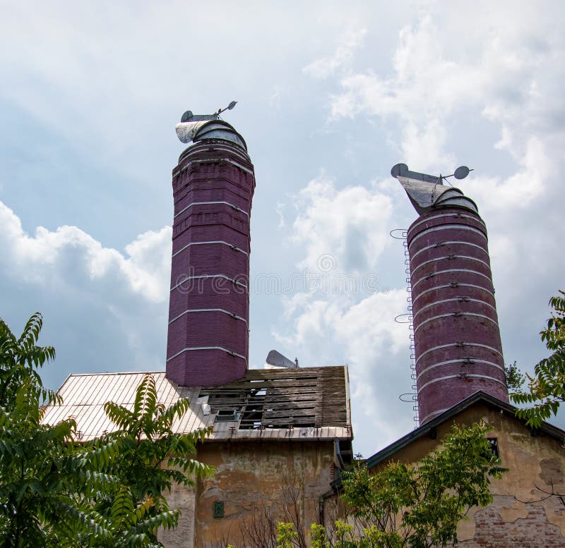 Original chimneys of an old brewery against the blue sky. The old building of the brewery in the city of Nitra, Slovakia
