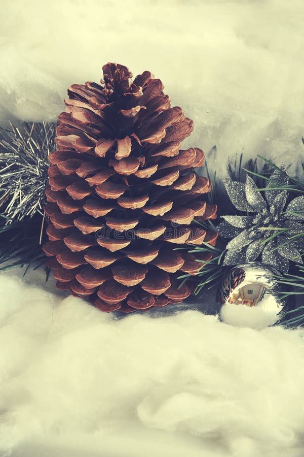 Original Christmas decoration with a large pine cone on a delic