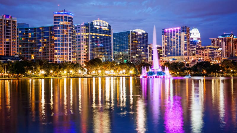 Orlando, Florida City Skyline on Lake Eola at Night logos blurr