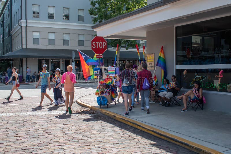 Couple selling rainbow flag in corner in Come Out With Pride Orlando parade at Lake Eola Park area 181