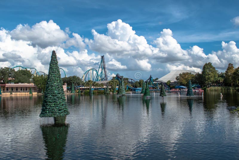 Panoramic view of Christmas trees on blue lake and rollercoaster at Seaworld 3 stock image Panoramic view of Christmas trees on blue lake and rollercoaster at Seaworld 3 stock image