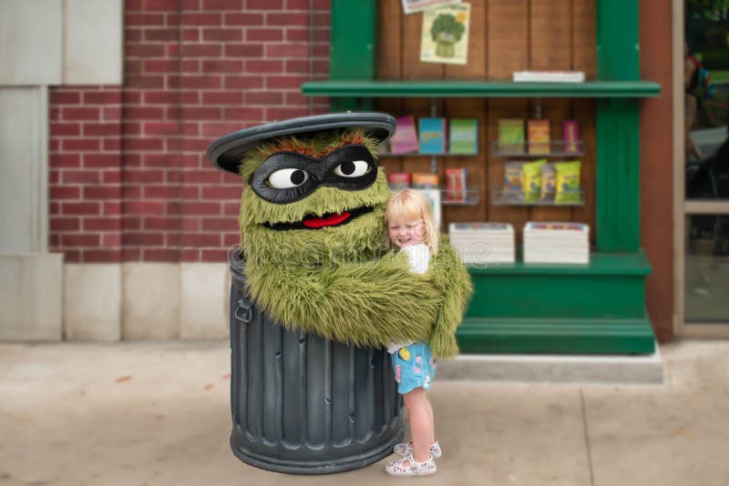 Oscar the Grouch with little girl in Sesame Street Party Parade at Seaworld.