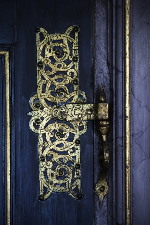 Gpold Ornametal Hinge On A blue Door