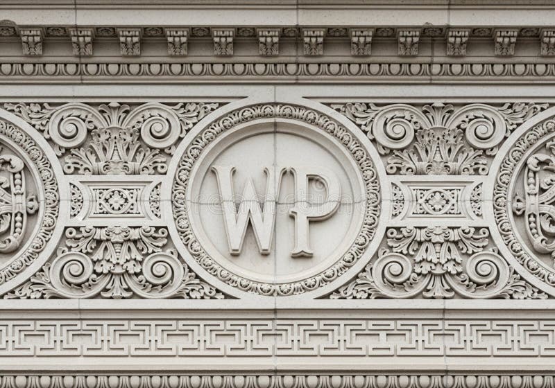 Ornate architectural detail featuring a bas-relief with initials \'WP\' set within a circular frame. stock illustration