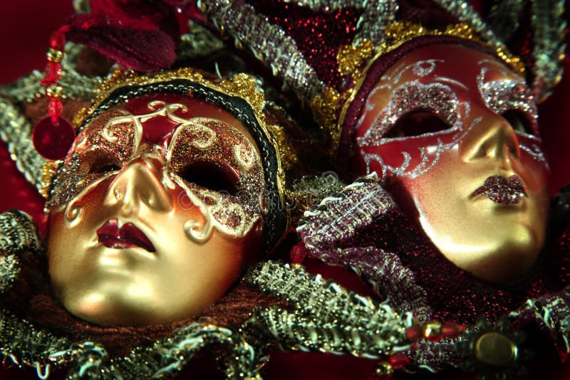 Ornate carnival masks over textured metallic background