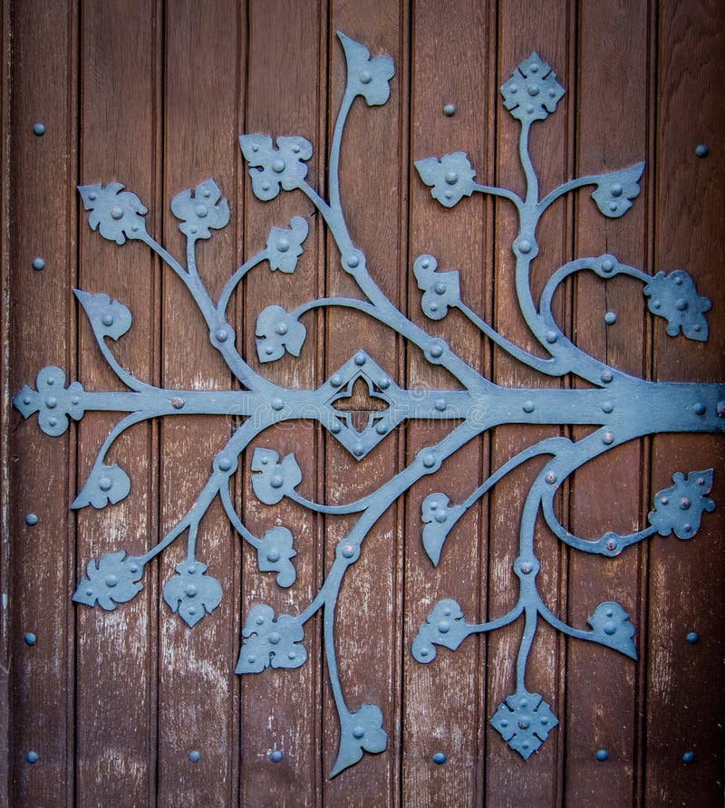 Rustic Ornametal Hinge On A Wooden Church Door. Rustic Ornametal Hinge On A Wooden Church Door