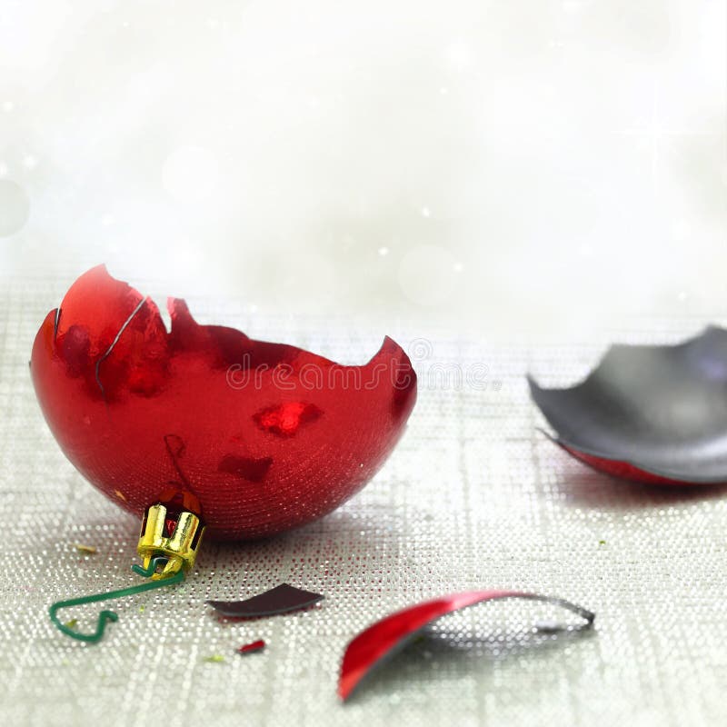 Broken red Christmas ornament with bokeh background. Broken red Christmas ornament with bokeh background