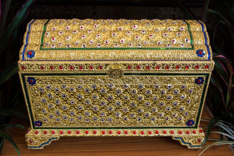 Treasure chest gold on the table. Thai gold treasure chest. Antique Thailand Treasure box background. Treasure chest gold on the table. Thai gold treasure chest. Antique Thailand Treasure box background