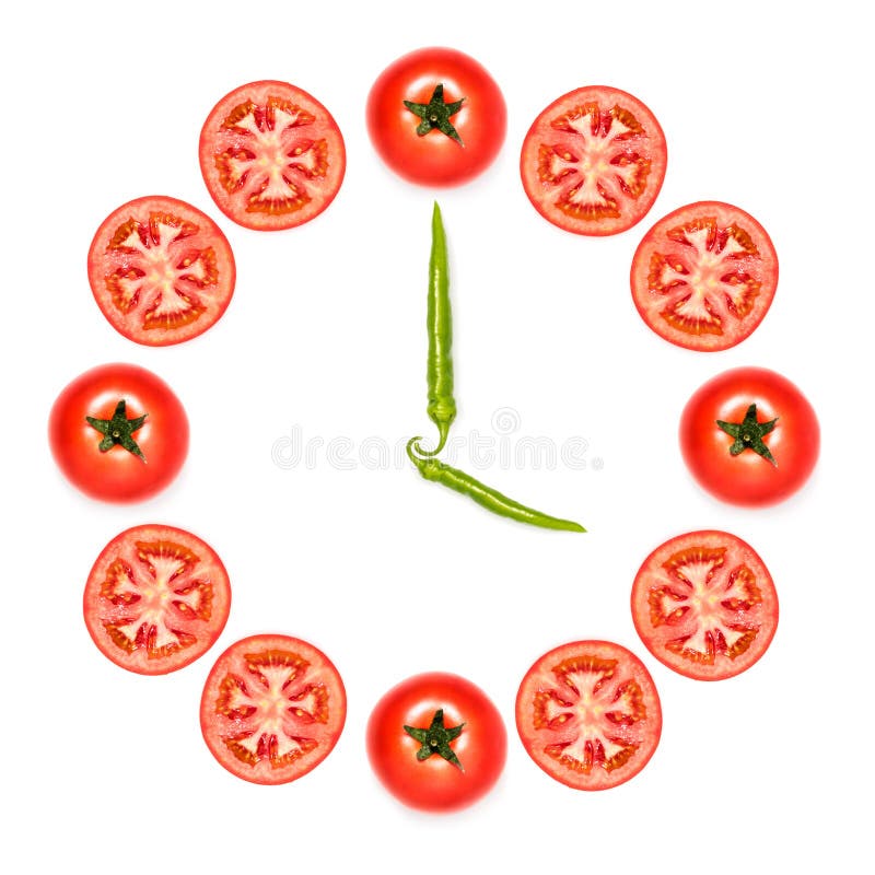 Orologio fatto dei pomodori e dei peperoni immagini stock