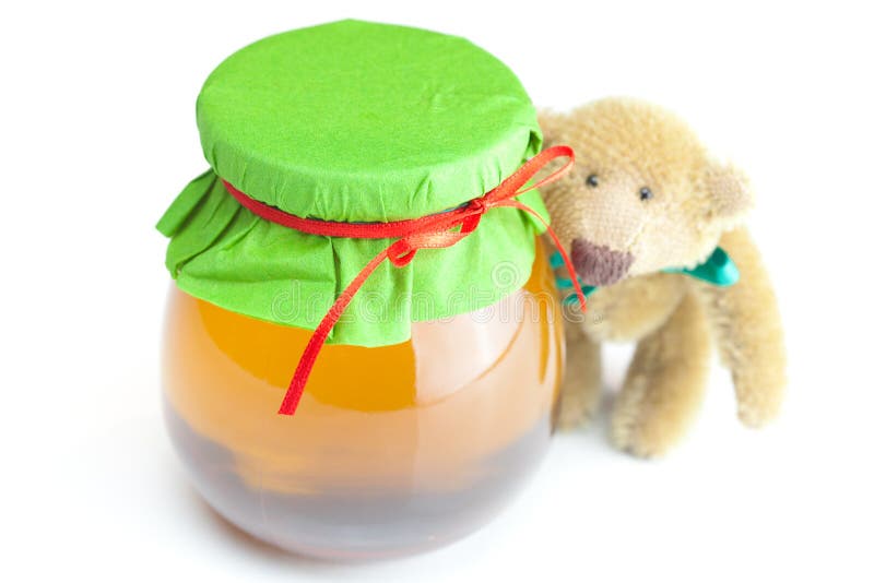 Orso dell'orsacchiotto e vaso di miele fotografia stock Orso dell'orsacchiotto e vaso di miele fotografia stock